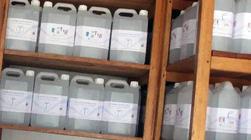 Dozens of Tatirano water cans on the shelves in a shop